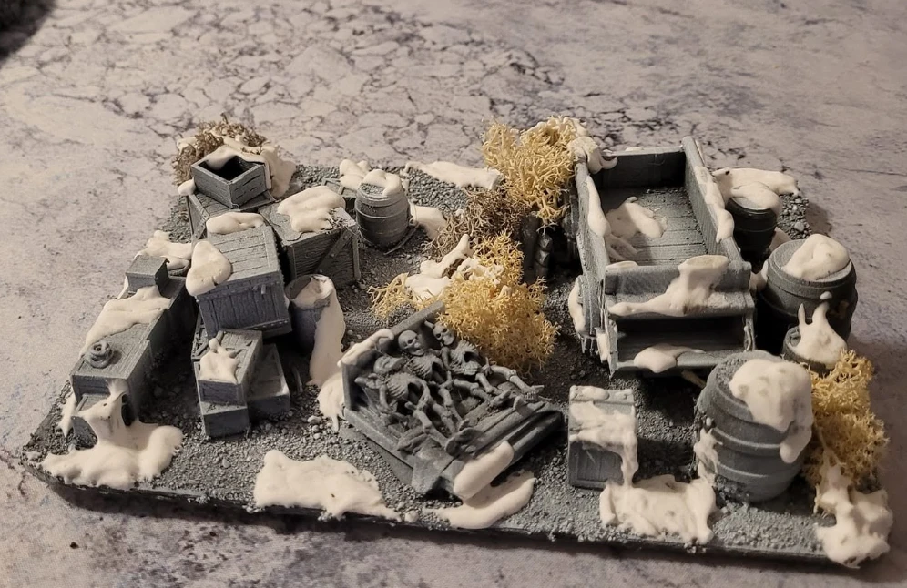 Snowy supply yard with crates and barrels